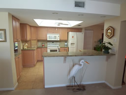 The kitchen is centrally located, with a dining bar